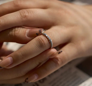 Close-up of a woman's finger showcasing Twist Diamond Silver Ring
