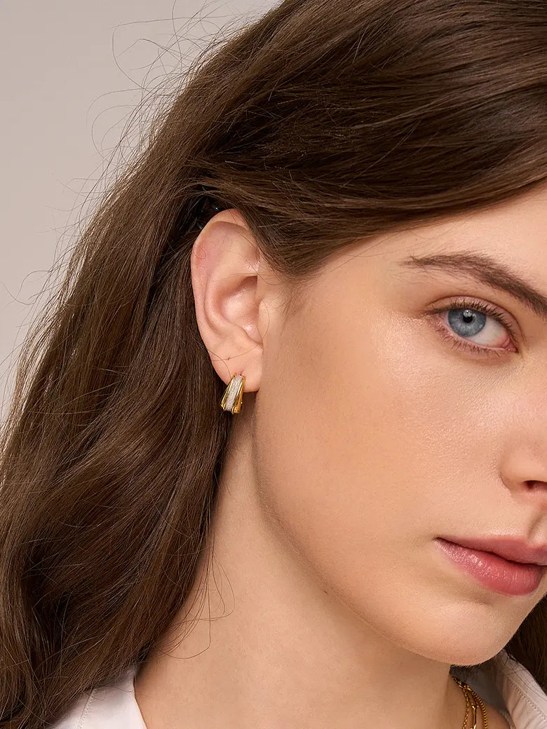 Close-up of a woman's ear showcasing Two Tone Geometric Stud Earrings