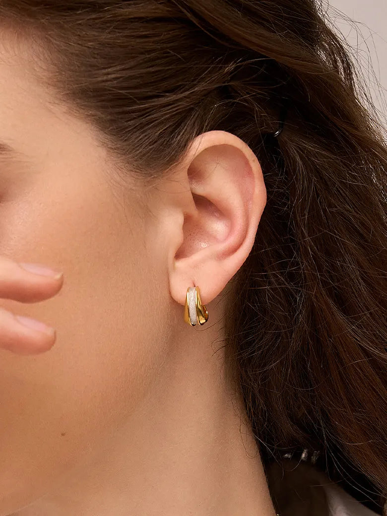 Close-up of a woman's ear showcasing Two Tone Geometric Stud Earrings