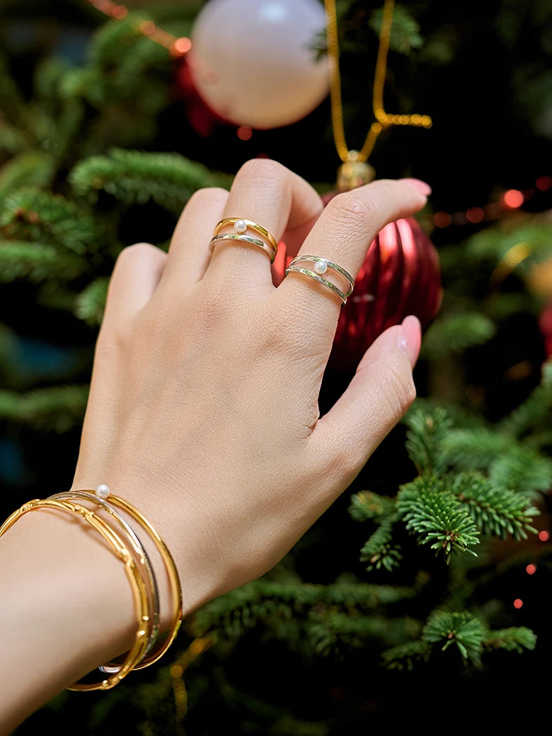 Close-up of a woman's finger showcasing Two Tone Pearl Ring