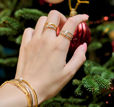 Close-up of a woman's finger showcasing Two Tone Pearl Ring
