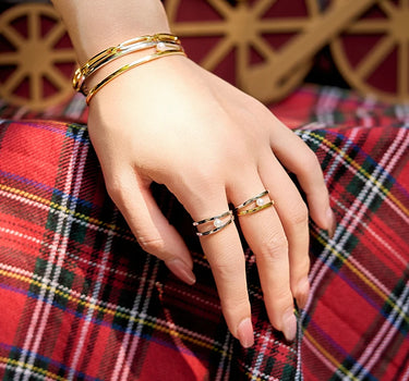 Close-up of a woman's finger showcasing Two Tone Pearl Ring