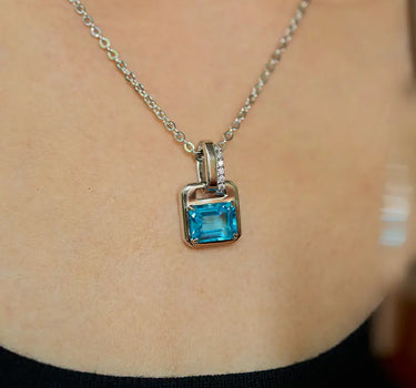 Close-up of a woman's neck showcasing Versailles Topaz Pendant Charm