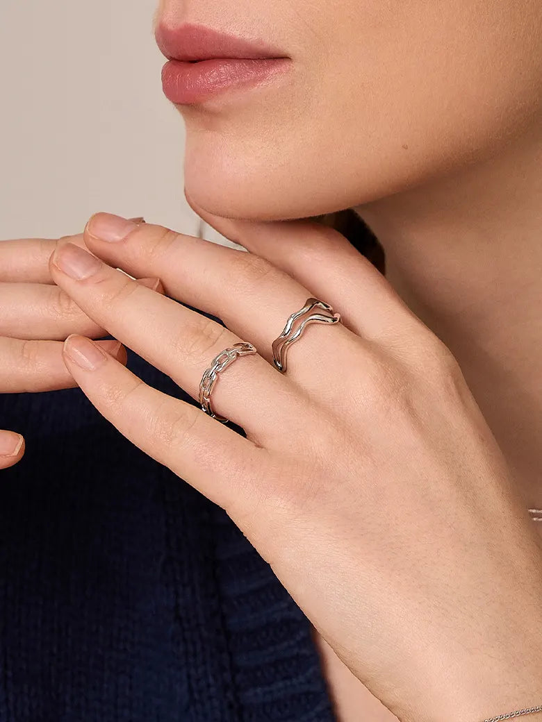 Close-up of a woman's finger showcasingWaveStackingSilverRing