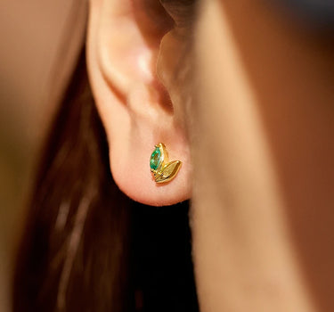 Close-up of a woman's ear showcasingWheatEmeraldAsymmetricEarrings